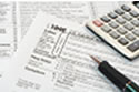 Income Tax Forms pen and calculators used to fill out tax returns